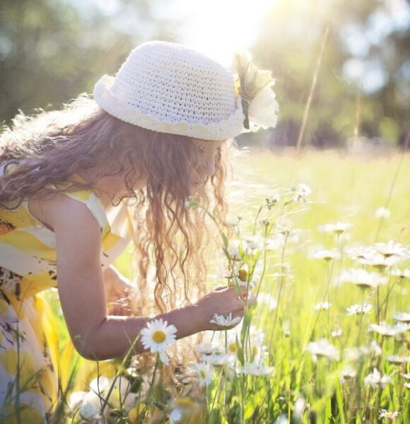 Child Smelling Flowers